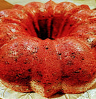 Whole red velvet cake topped with chocolate chips