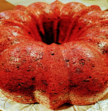 Whole red velvet cake topped with chocolate chips