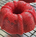 Whole red velvet cake topped with chocolate chips