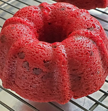 Whole red velvet cake topped with chocolate chips